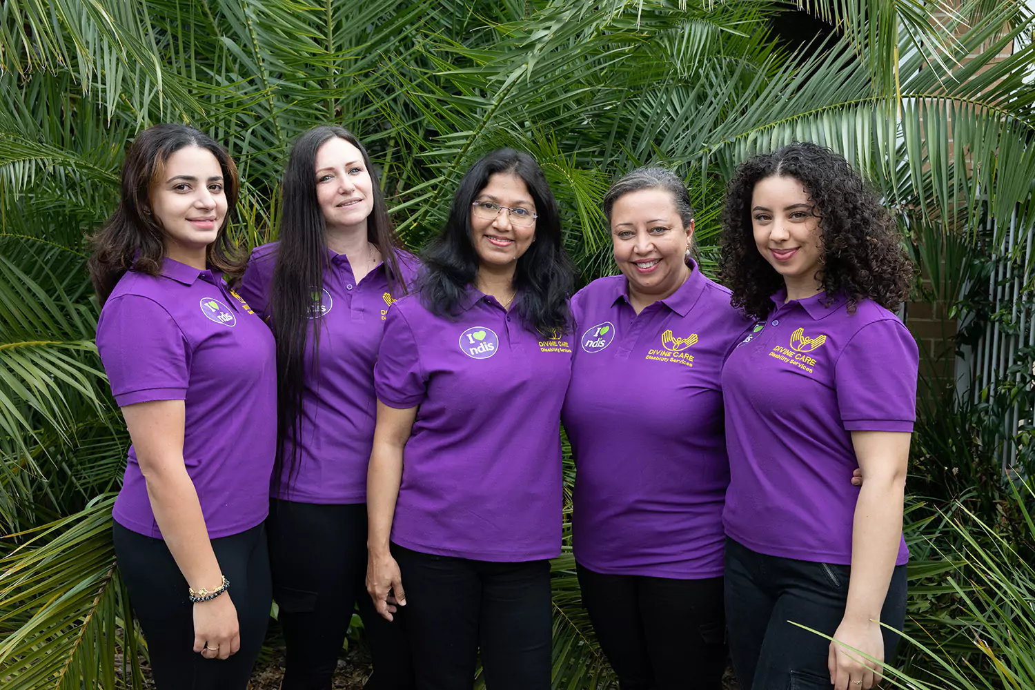 Divine Care Australia support workers standing together smiling at camera