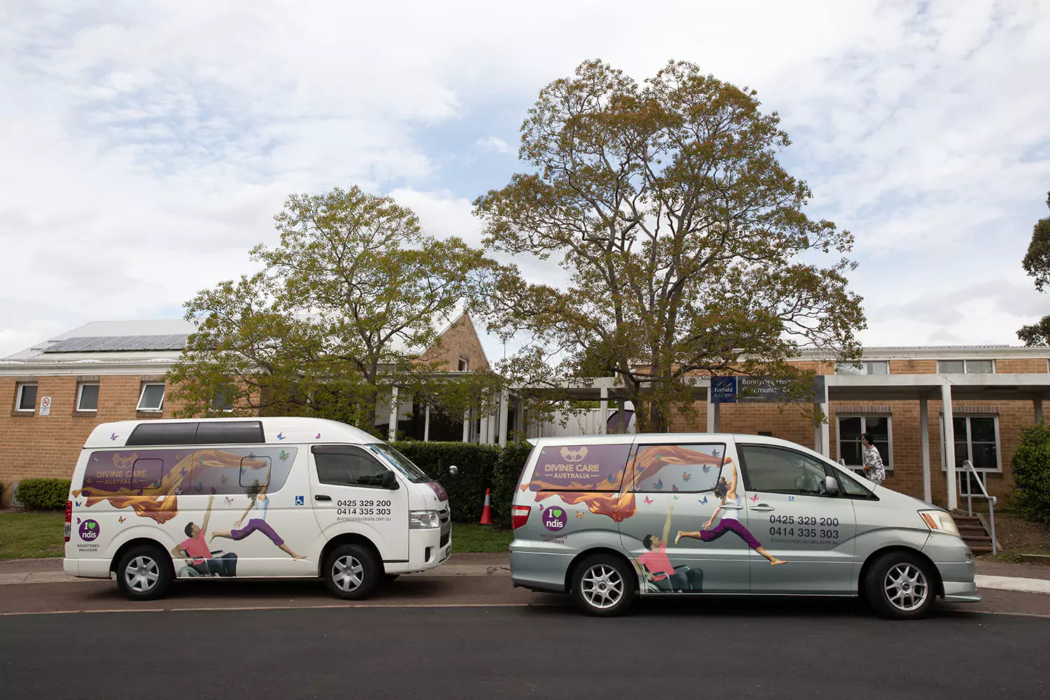 Two Divine Care Australia vans parked on street